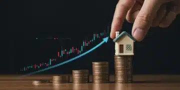 Hand placing house on coins with rising interest rate graph, symbolizing Fed rate hike impact.
